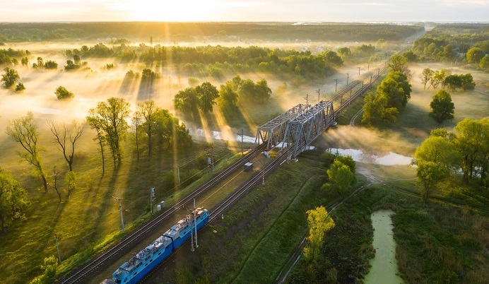 Train crossing a bridge at sunset